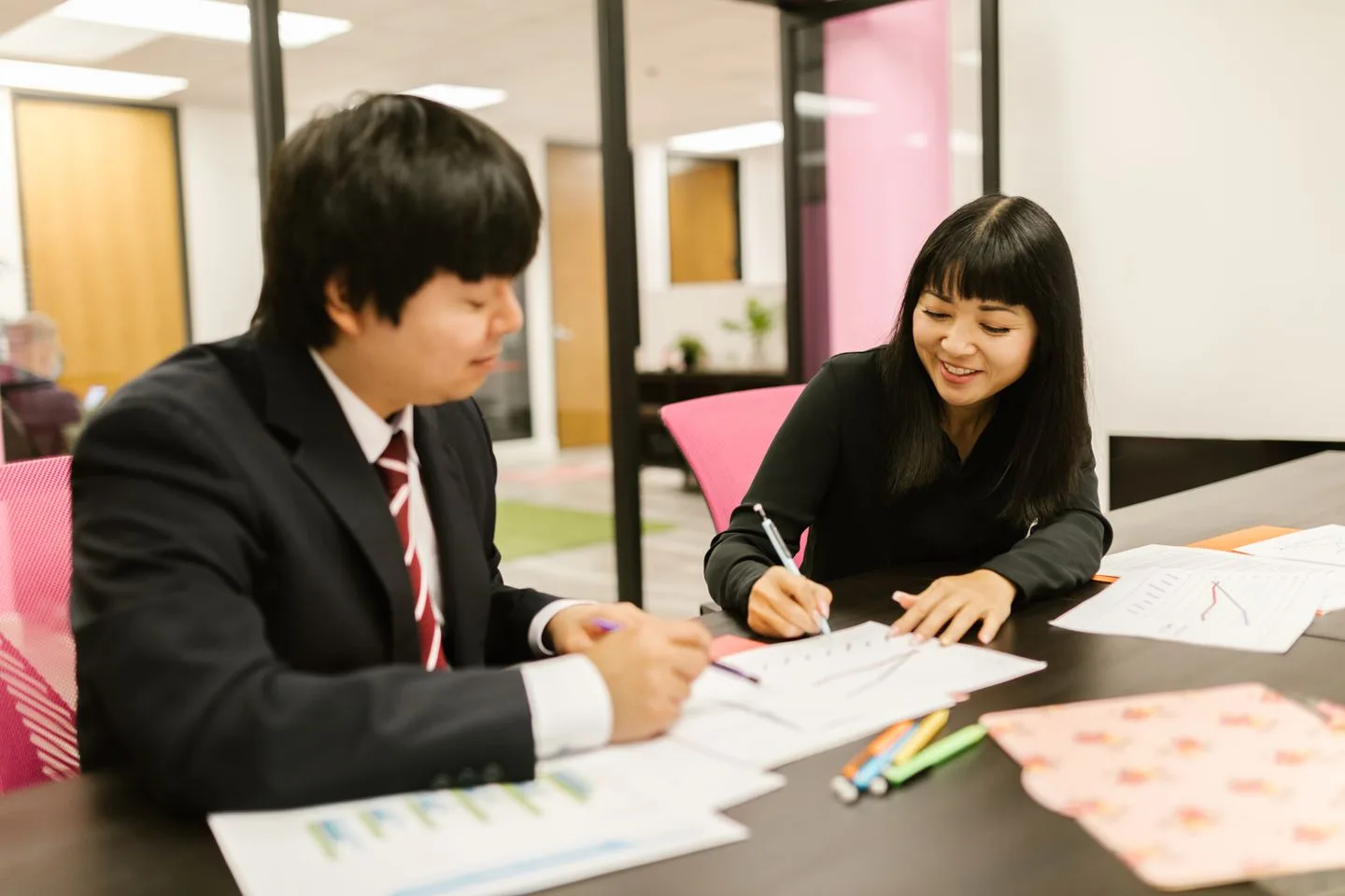 Two colleagues sharing knowledge over documents