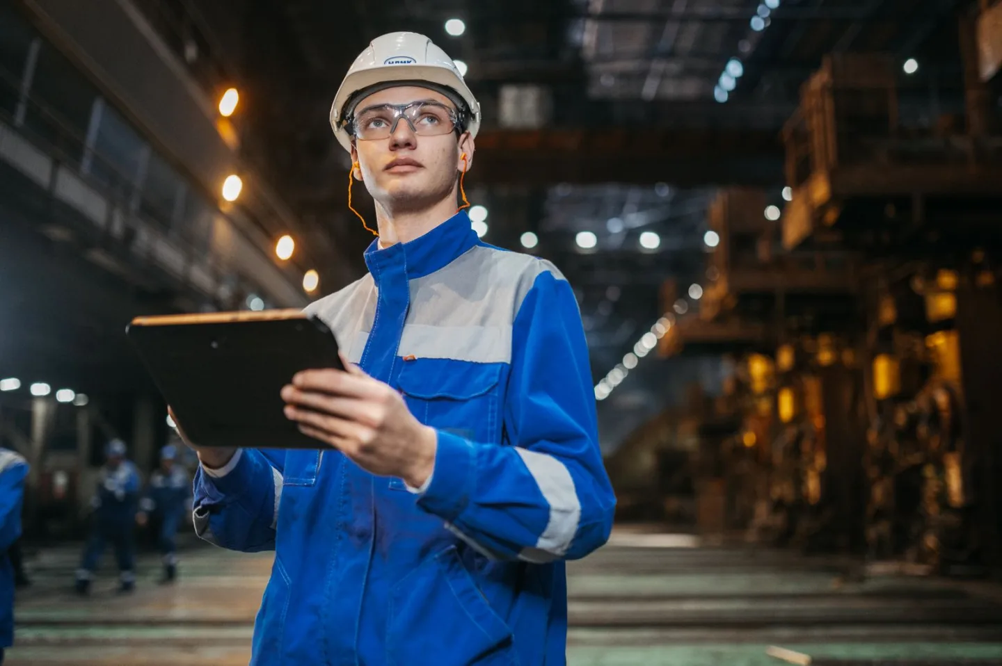 Engineer holding a tablet on an industrial factory floor